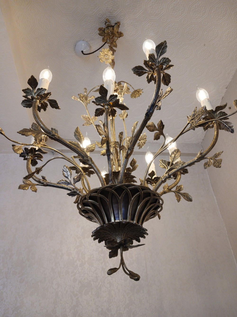 A French gilt bronze chandelier featuring leaf and floral motifs arranged in a basket form with candle bulb sockets. View II