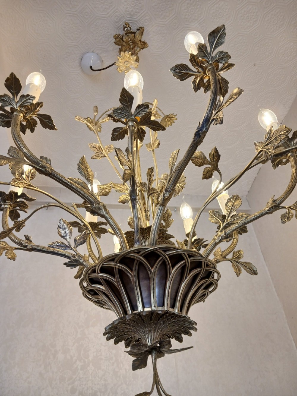 A French gilt bronze chandelier featuring leaf and floral motifs arranged in a basket form with candle bulb sockets. View IV