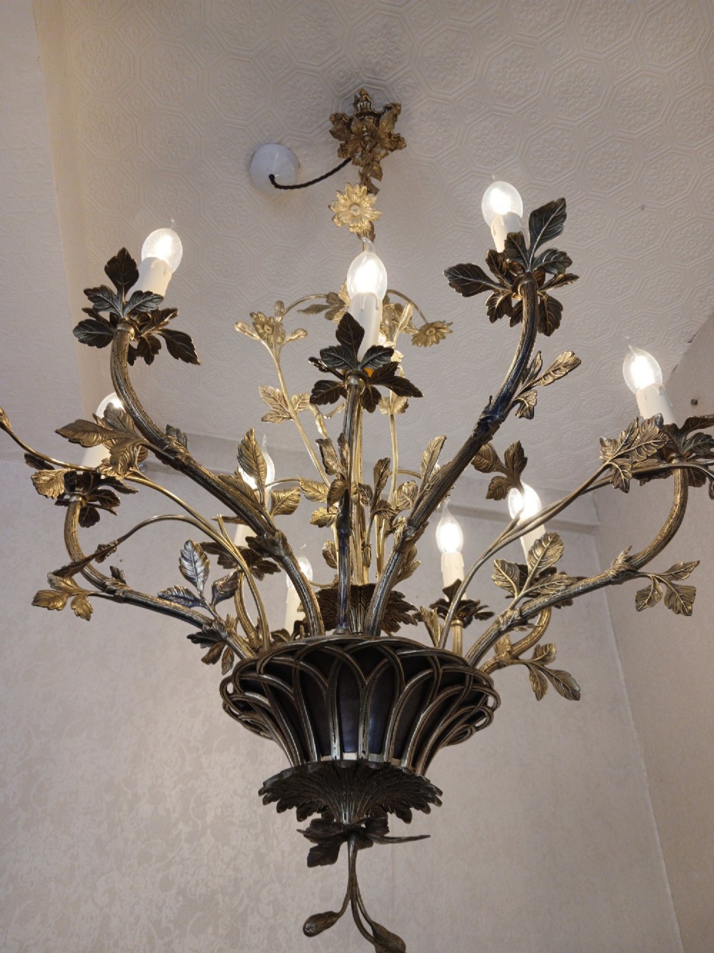 A French gilt bronze chandelier featuring leaf and floral motifs arranged in a basket form with candle bulb sockets. View V