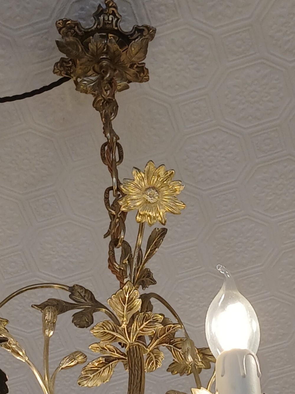 A French gilt bronze chandelier featuring leaf and floral motifs arranged in a basket form with candle bulb sockets. View VII