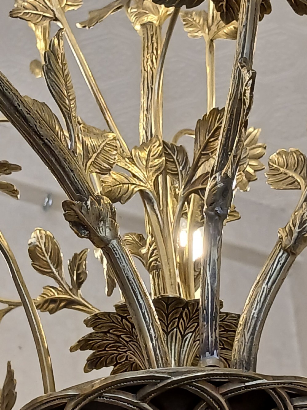 A French gilt bronze chandelier featuring leaf and floral motifs arranged in a basket form with candle bulb sockets. View IX