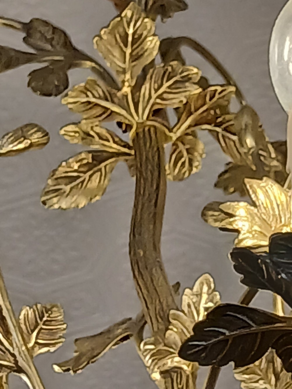 A French gilt bronze chandelier featuring leaf and floral motifs arranged in a basket form with candle bulb sockets. View XII