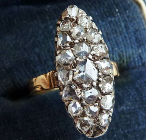 fig 1. A Victorian navette cluster ring showcasing rose cut diamonds set in silver atop an 18ct yellow gold band.