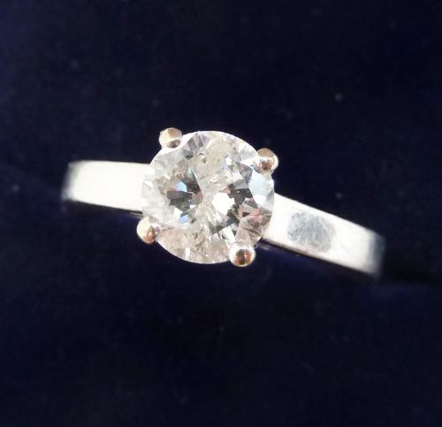 fig 1. An 18ct white gold Art Deco ring featuring a round central diamond set in a four-claw mount.