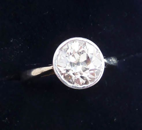 fig 1. An Art Deco platinum ring featuring a circular old European cut diamond set in a smooth bezel collar on a slim band.