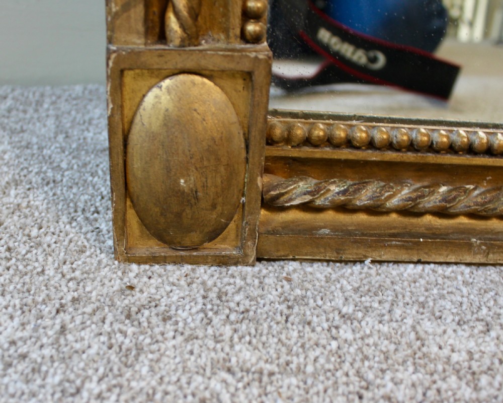 A tall rectangular antique giltwood pier mirror featuring rope-twist moulding and rosette corner blocks. View VI