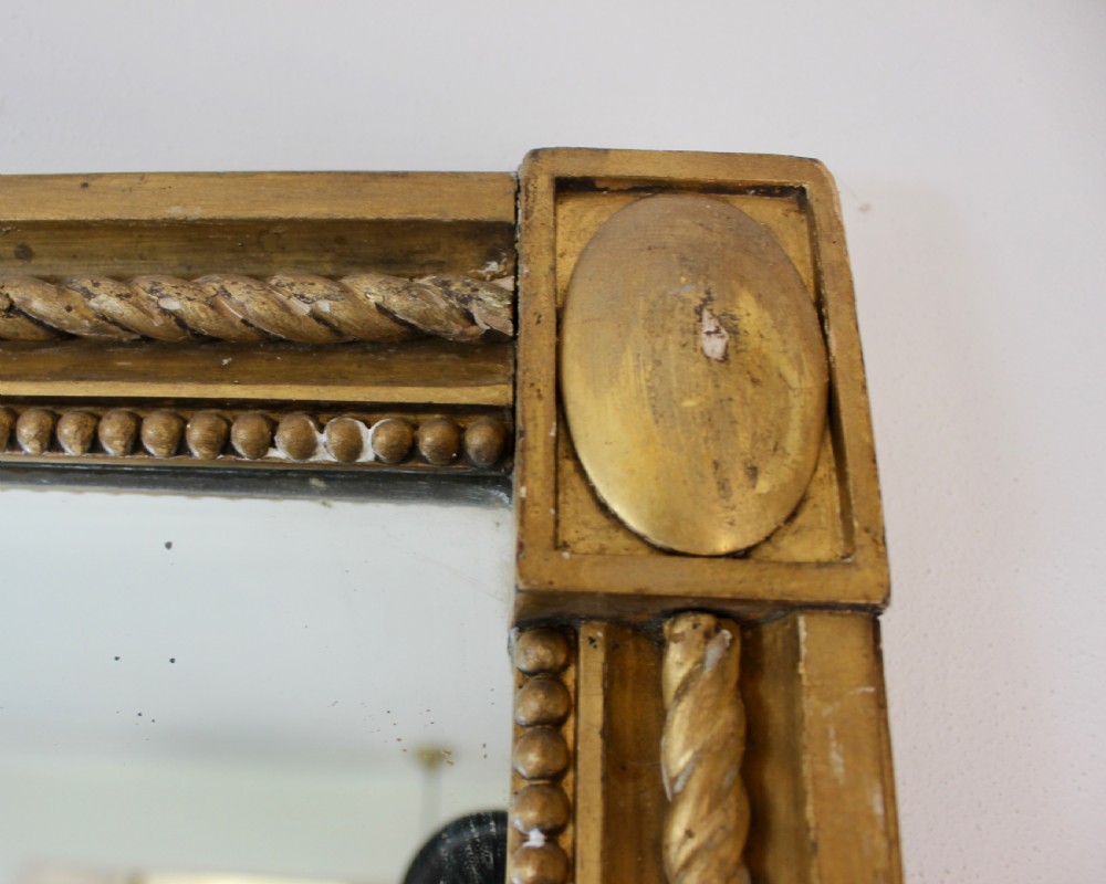 A tall rectangular antique giltwood pier mirror featuring rope-twist moulding and rosette corner blocks. View VII