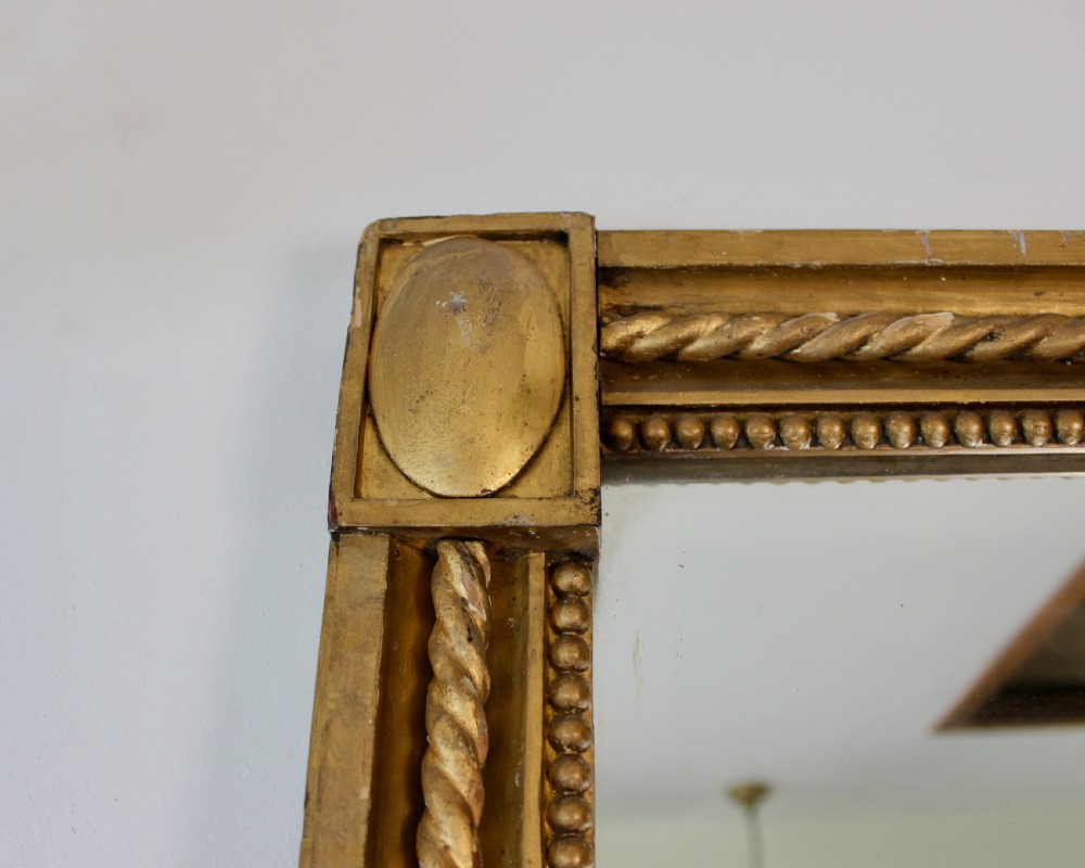 A tall rectangular antique giltwood pier mirror featuring rope-twist moulding and rosette corner blocks. View VIII