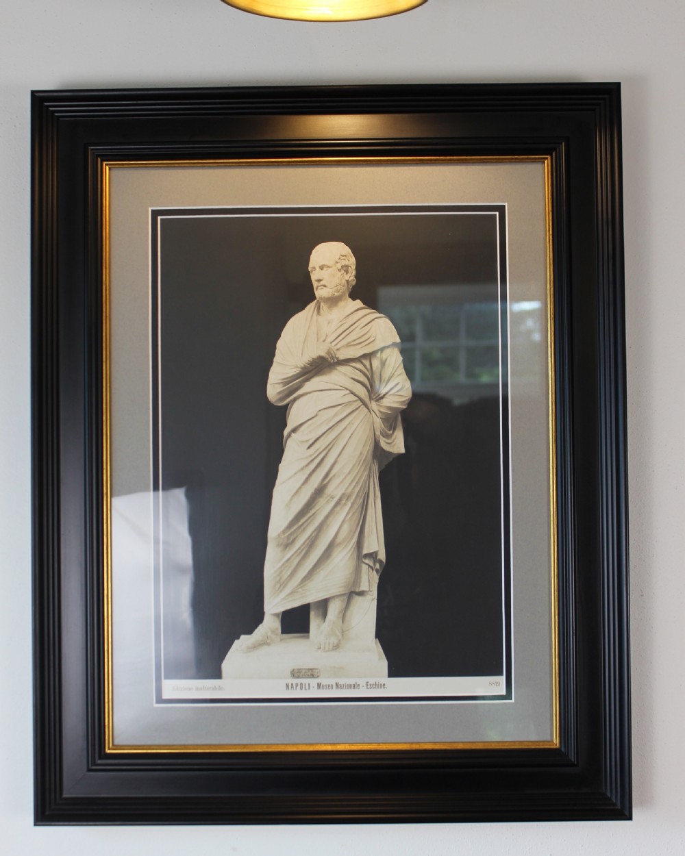 A pair of black and white framed photographic prints depicting ancient classical statues from the Naples National Archaeological Museum in dark stepped frames with gold accents. View II