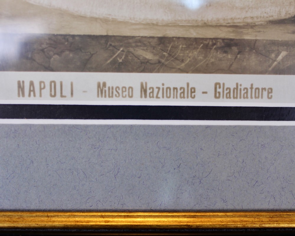 A pair of black and white framed photographic prints depicting ancient classical statues from the Naples National Archaeological Museum in dark stepped frames with gold accents. View XI