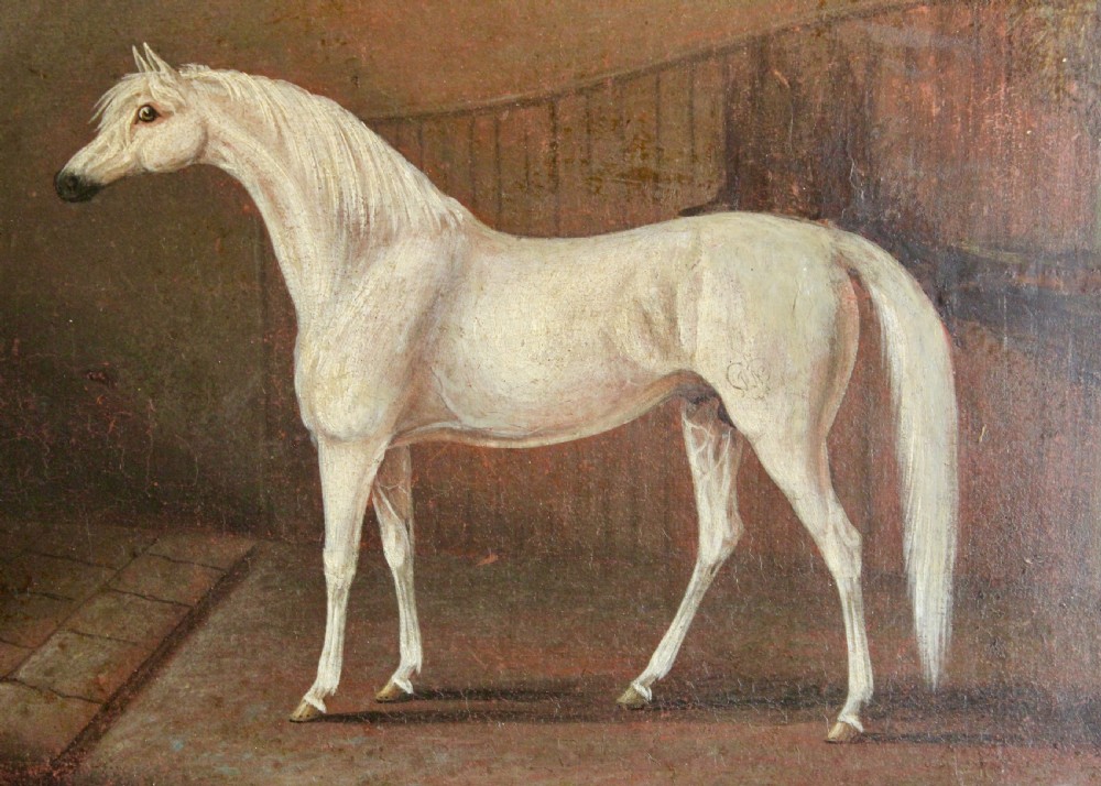 An early 19th-century oil painting depicting a white stallion in profile inside a dimly lit stable, presented in a black ebonised frame with a gilded inner slip. View II