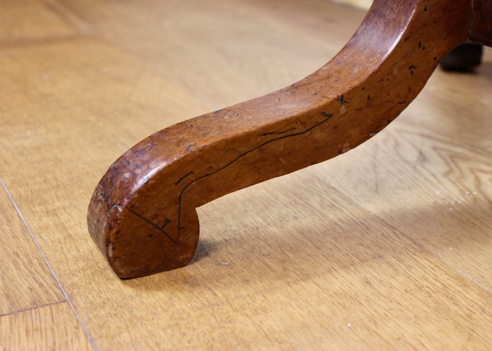 An antique William and Mary walnut candle stand featuring an octagonal top, a central barley-twist column, and a tripod base. View VI