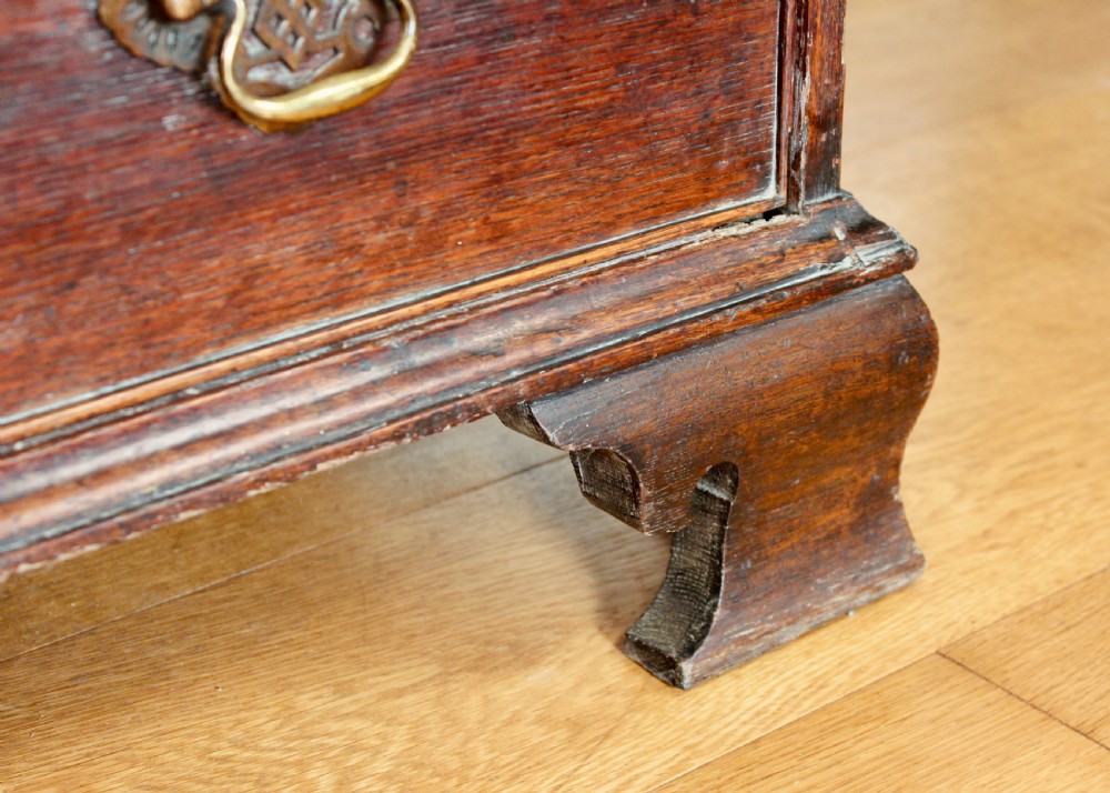 A tall George III dark oak chest-on-chest featuring two short over five long graduated drawers adorned with ornate brass handles and supported on ogee bracket feet. View VI