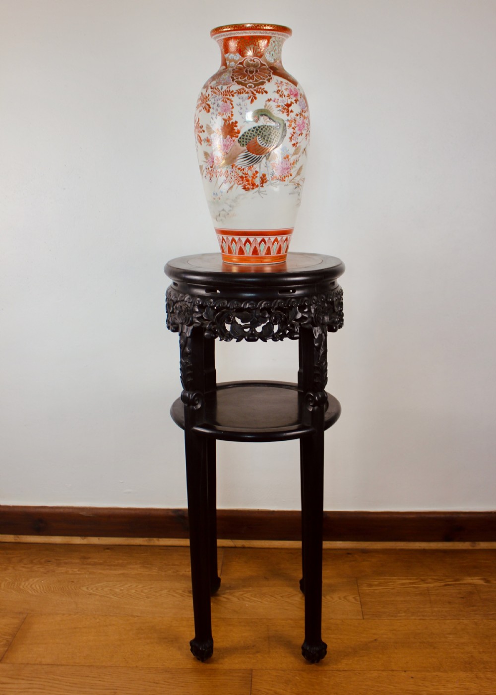 A tall dark hardwood circular jardiniere stand featuring an inset marble top, a pierced carved frieze, a lower circular undertier, and four slender legs. View III