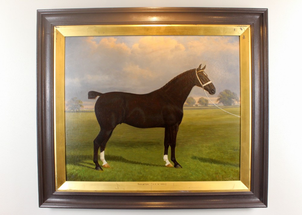 An antique framed oil painting depicting a dark brown Hackney horse standing in profile across a green pasture under a cloudy sky. View V