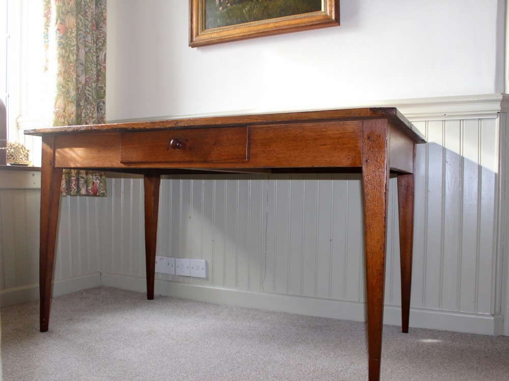 A 19th-century French provincial oak farmhouse table featuring a rectangular plank top, a single frieze drawer with a wooden knob, and four tapered square legs. View II