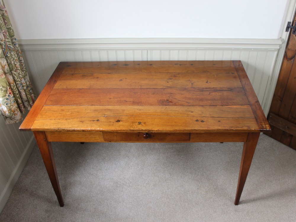 A 19th-century French provincial oak farmhouse table featuring a rectangular plank top, a single frieze drawer with a wooden knob, and four tapered square legs. View III