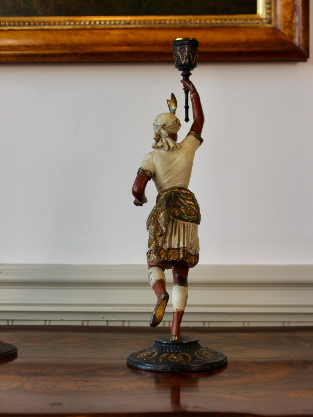 A pair of antique cold-painted spelter figural candlesticks depicting male and female figures in Orientalist attire holding raised torch nozzles. View VI