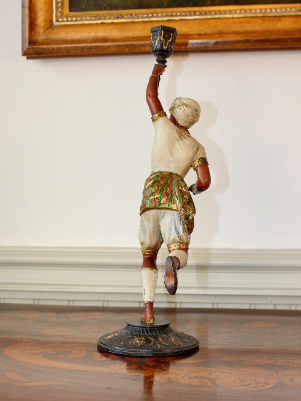 A pair of antique cold-painted spelter figural candlesticks depicting male and female figures in Orientalist attire holding raised torch nozzles. View VIII