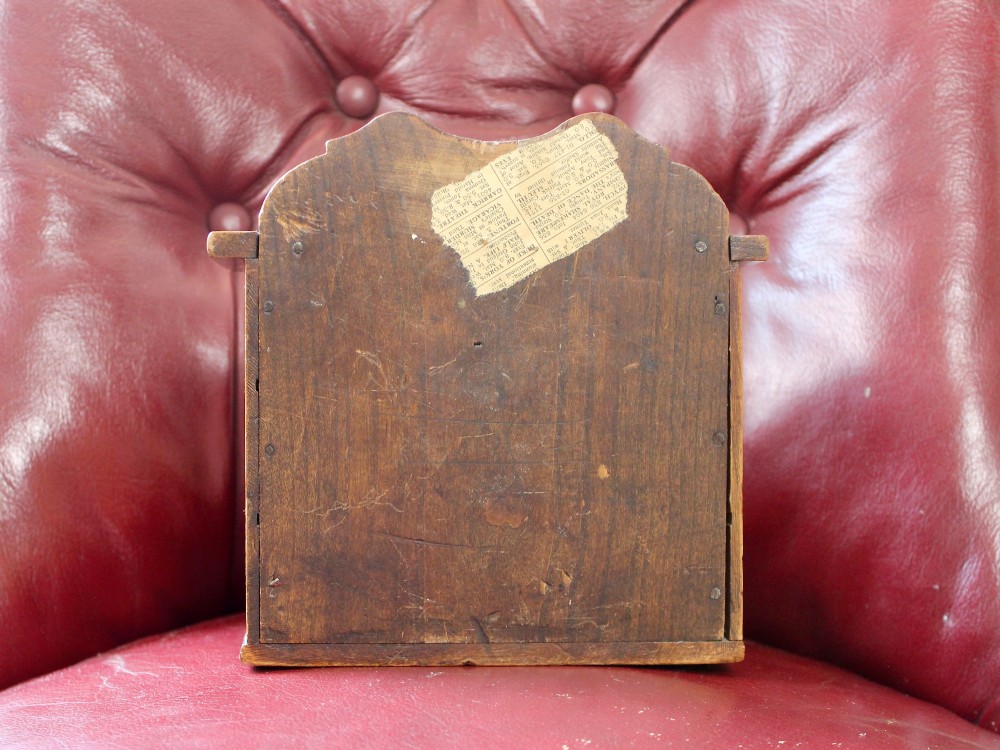 A small 19th-century fruitwood spice chest featuring six individual drawers with small brass knobs and a shaped back gallery. View VI