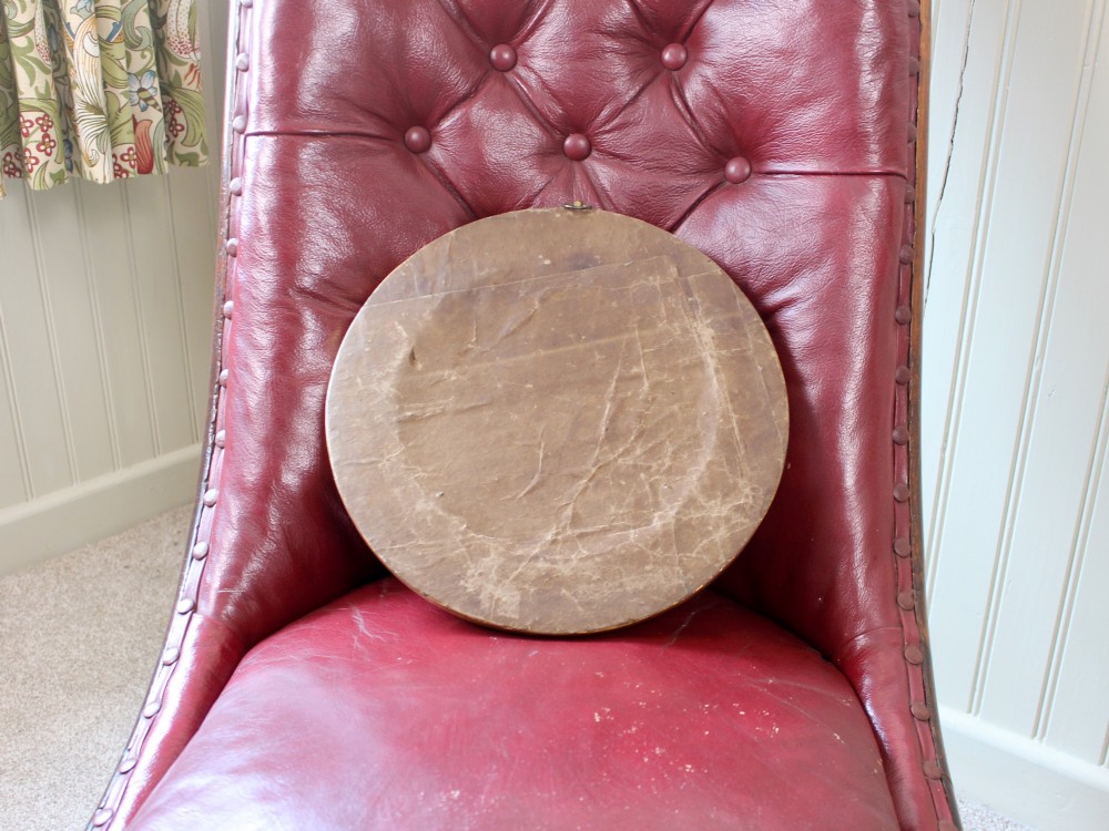 A circular 19th-century bronze bas-relief portrait plaque depicting a gentleman with a full beard in side profile, mounted in a gilded round frame. View V