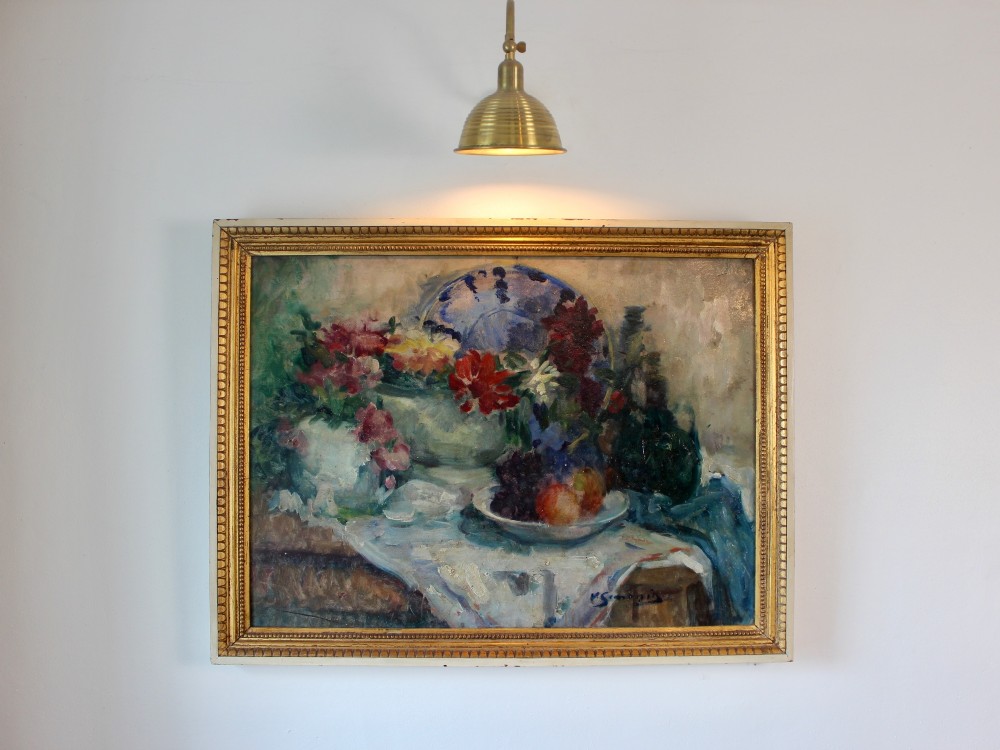 An impressionist still life oil painting on canvas depicting flowers and fruit in ceramic vessels, set within a beaded gilt wooden frame.