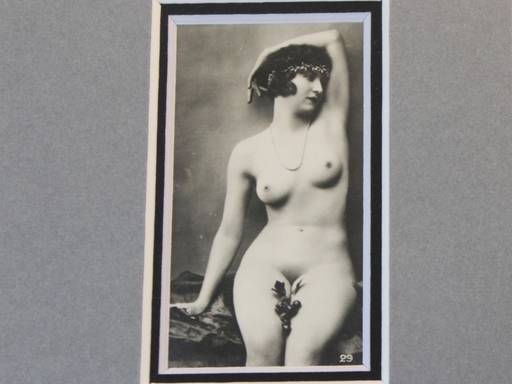 A dark frame displaying ten 1920s monochrome photographic prints of female nudes by Julian Mandel arranged in two rows against a grey mount. View VI