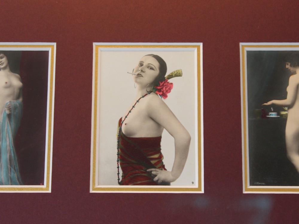 An array of eight 1920s hand-tinted female nude photographs mounted on a burgundy mat within a moulded gold frame. View IV