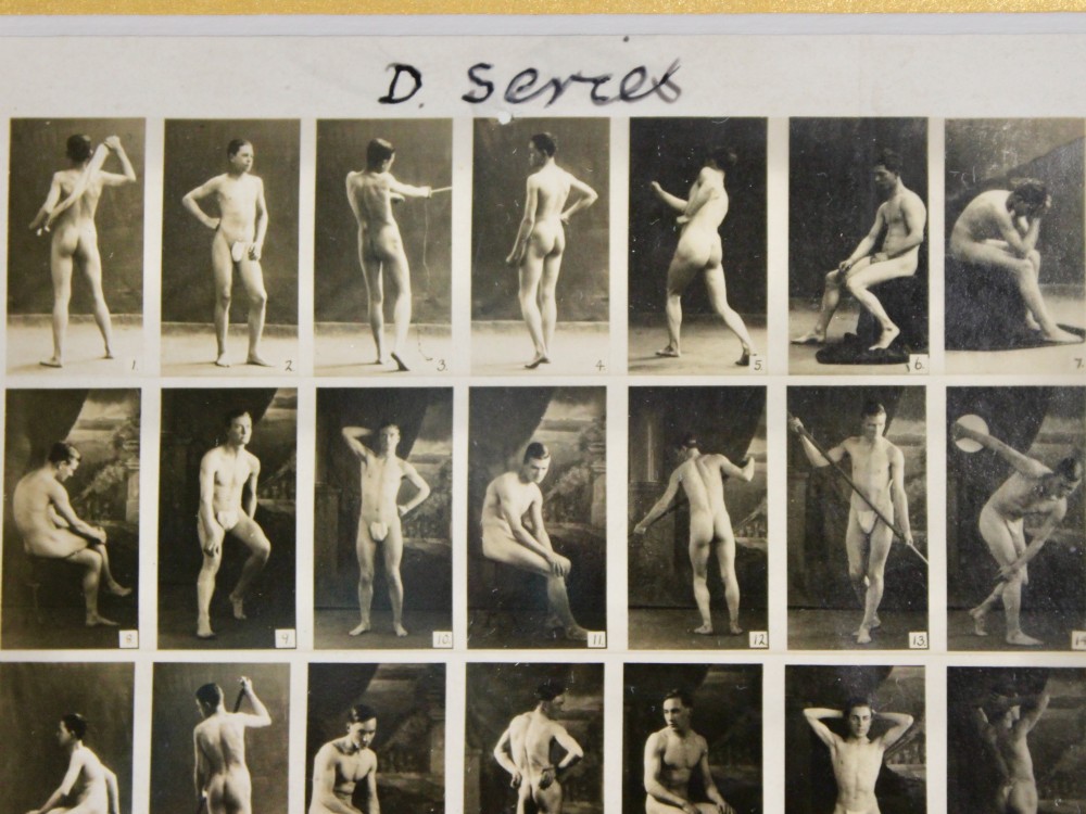 A framed 1920s monochrome photographic contact sheet displaying multiple male nude poses, mounted on burgundy card within a dark timber frame with gilt detailing. View VII