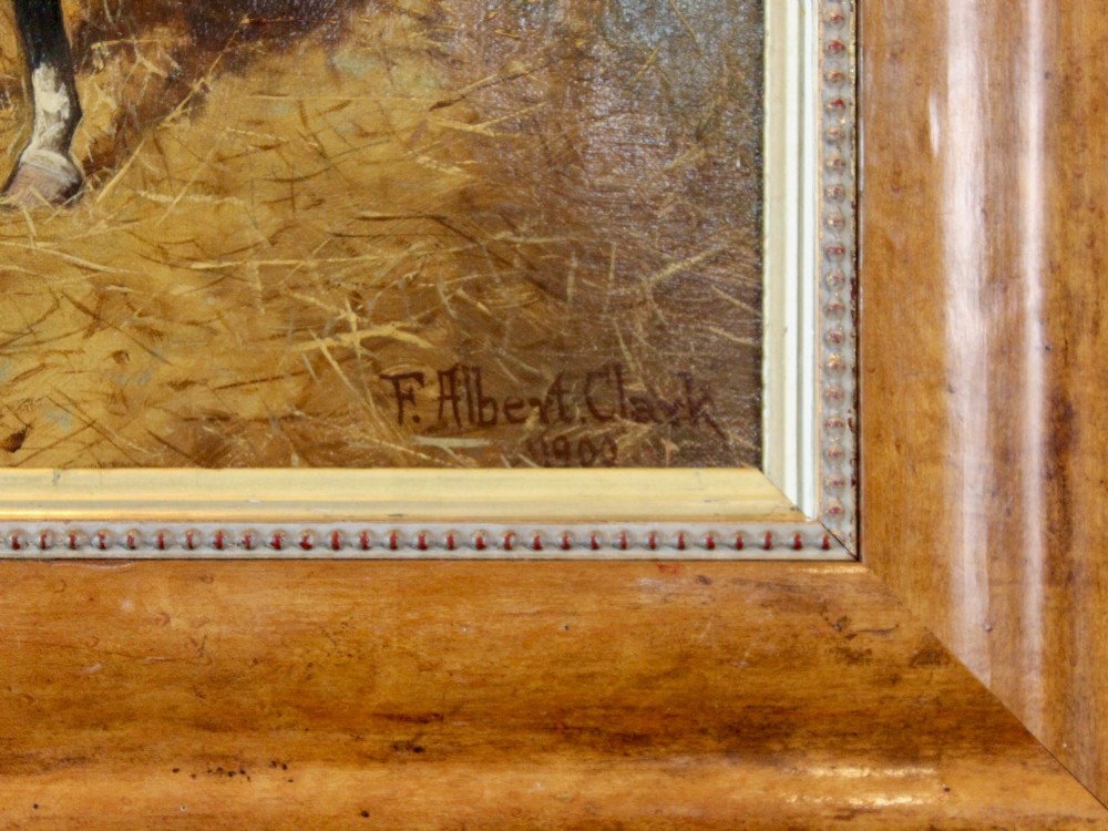 An antique oil painting depicting a bay horse standing inside a straw-filled stable within a wide timber frame. View II