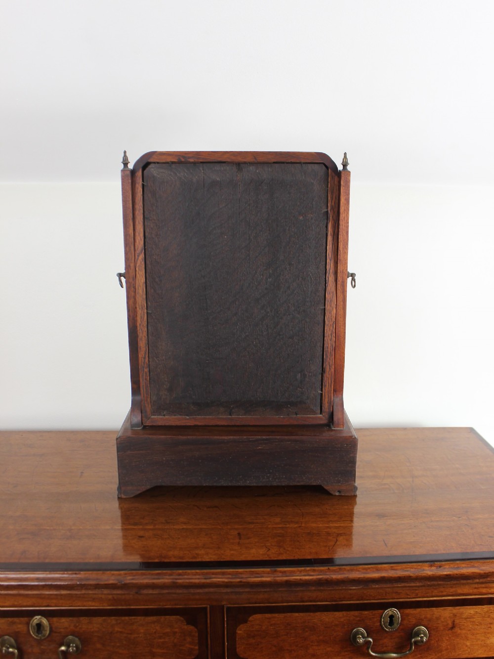 A George II mahogany dressing mirror featuring a swivel glass plate with a parcel-gilt frame resting on a three-drawer base. View IX