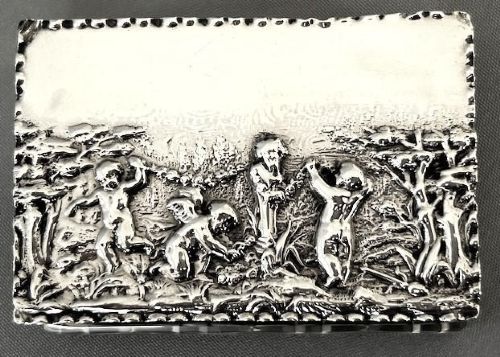 fig 1. An Edwardian rectangular cut glass double stamp box featuring an embossed sterling silver lid decorated with classical cherub figures.