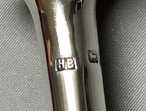 fig 1. A Victorian sterling silver candle snuffer fashioned in the shape of a long, tapered hunting horn with a flared mouth.