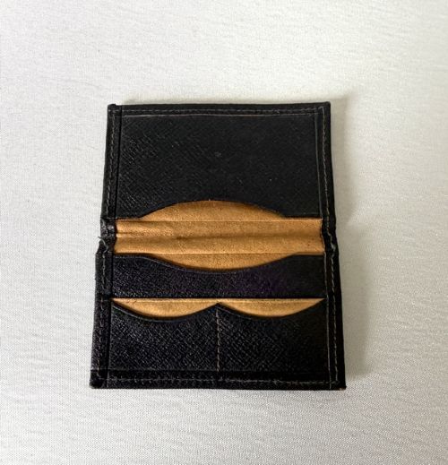 A small dark brown textured leather stamp wallet featuring a hallmarked sterling silver monogram mount shaped as the letter B. View IV