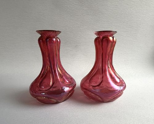 A pair of Art Nouveau hand-blown glass stem vases featuring a bulbous lobed design with a magenta and golden iridescent finish. View III
