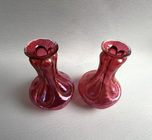 A pair of Art Nouveau hand-blown glass stem vases featuring a bulbous lobed design with a magenta and golden iridescent finish. View IV