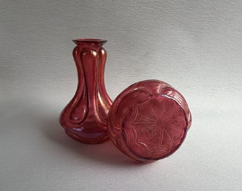 A pair of Art Nouveau hand-blown glass stem vases featuring a bulbous lobed design with a magenta and golden iridescent finish. View V
