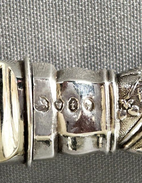 fig 1. A Victorian silver fish serving knife featuring an engraved river landscape scene on the blade and a chased spiral twist handle.