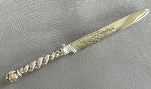 fig 2. A Victorian silver fish serving knife featuring an engraved river landscape scene on the blade and a chased spiral twist handle.