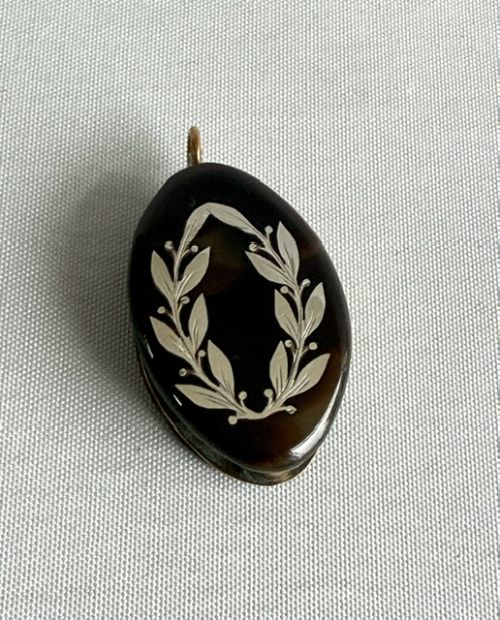 fig 1. A Victorian oval dark brown tortoiseshell folding loupe decorated with silver pique foliate inlay and featuring a swivelling circular magnifying glass lens.