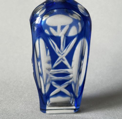 fig 1. A Victorian cobalt blue cut-to-clear glass scent flask featuring a silver collar and a faceted clear glass stopper.