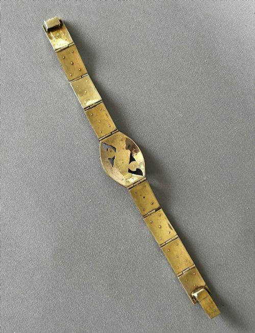 fig 1. An Art Deco silver gilt panel link bracelet featuring geometric leaf motifs inlaid with small cut paste stones.