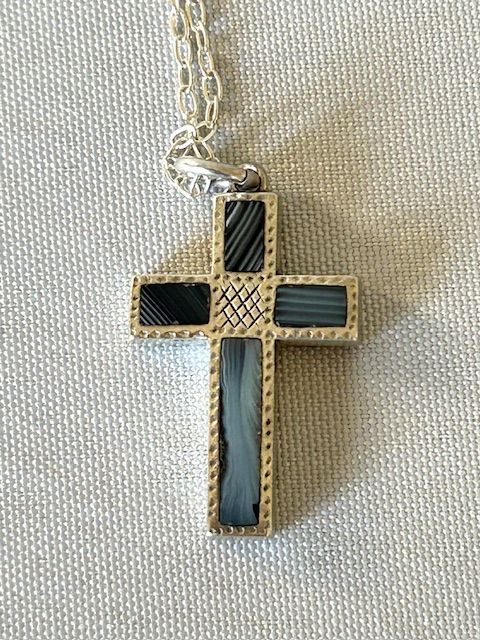fig 1. A Victorian silver cross pendant inlaid with grey and black striped Montrose agate panels, suspended on a fine silver link chain.