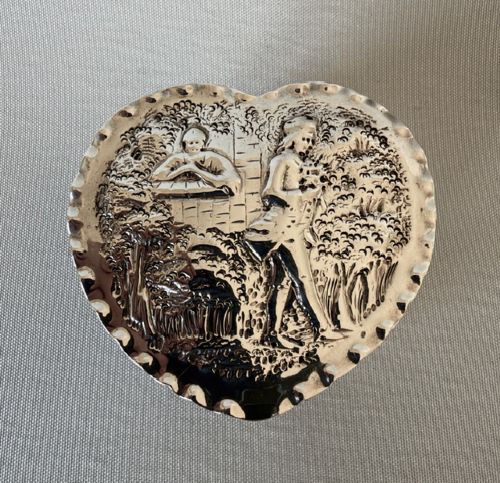 A small Victorian silver heart-shaped trinket box featuring an embossed romantic scene on the lid and reeded vertical sides. View VIII
