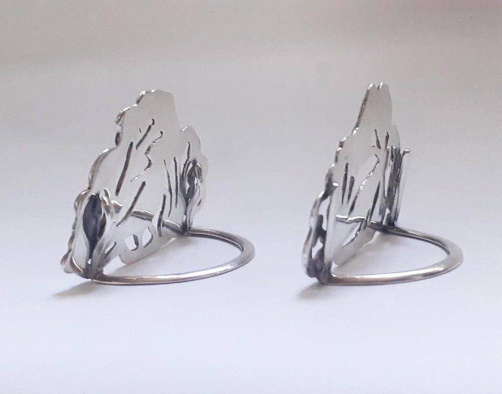 A pair of Victorian pierced sterling silver menu card holders featuring detailed bird and botanical foliage designs. View IV