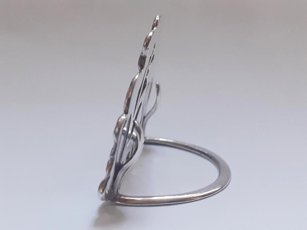 A pair of Victorian pierced sterling silver menu card holders featuring detailed bird and botanical foliage designs. View VI