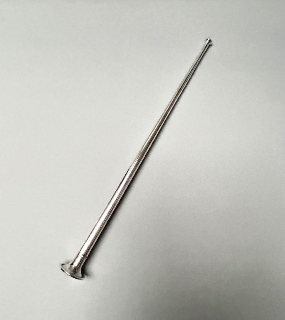 A Victorian sterling silver candle snuffer fashioned in the shape of a long, tapered hunting horn with a flared mouth. View V