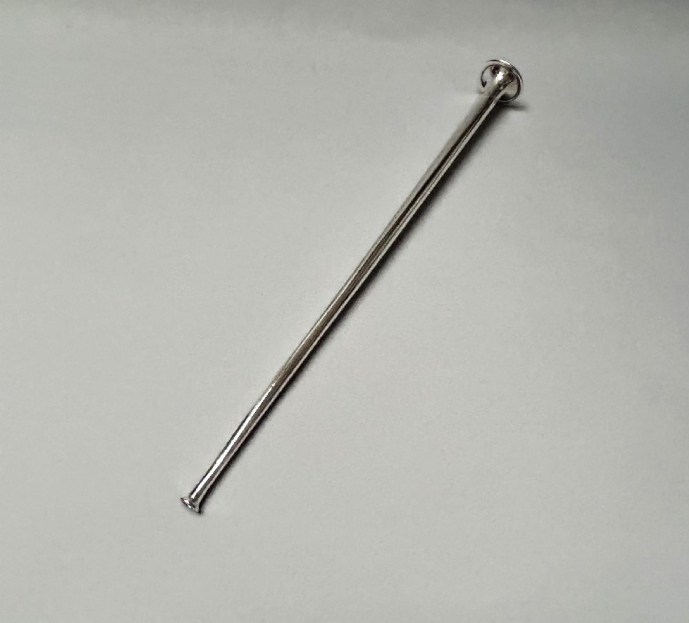 A Victorian sterling silver candle snuffer fashioned in the shape of a long, tapered hunting horn with a flared mouth. View VI