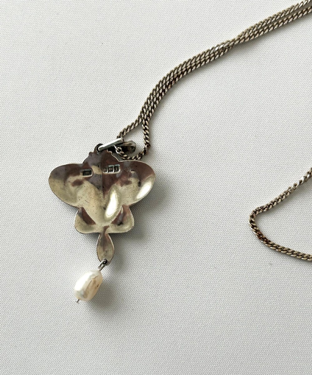 An Art Nouveau silver pendant necklace featuring green and blue enamel in an organic shape with a suspended pearl drop. View II