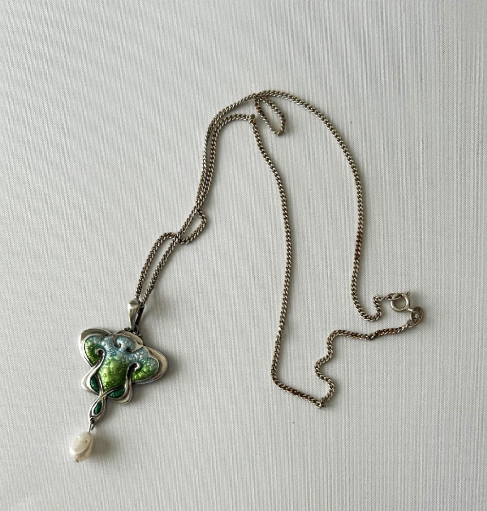 An Art Nouveau silver pendant necklace featuring green and blue enamel in an organic shape with a suspended pearl drop. View IV